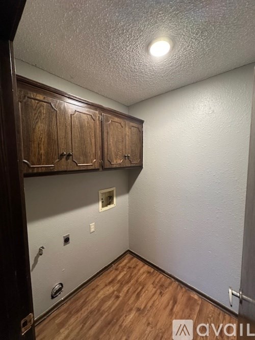 A room with wooden cabinets and a light on the ceiling.