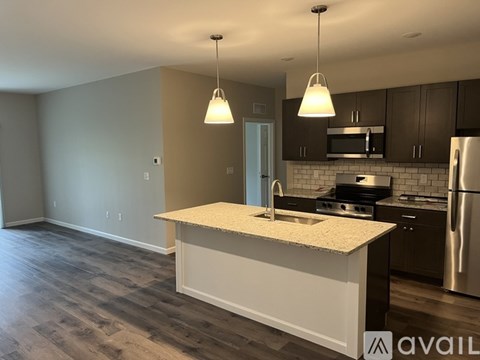 A kitchen with a white countertop and stainless steel appliances.