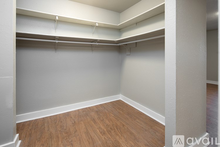 A room with wooden floors and white walls.