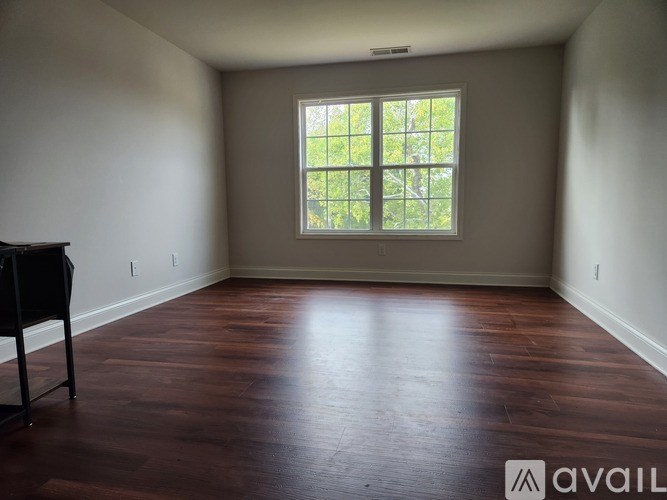 A room with a piano and a window.