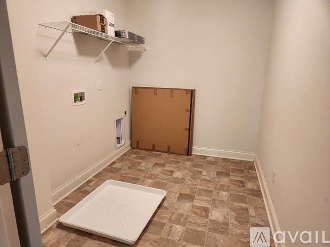 A room with a brown door and a white mat on the floor.