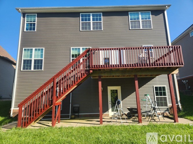 A house with a red staircase and a balcony.