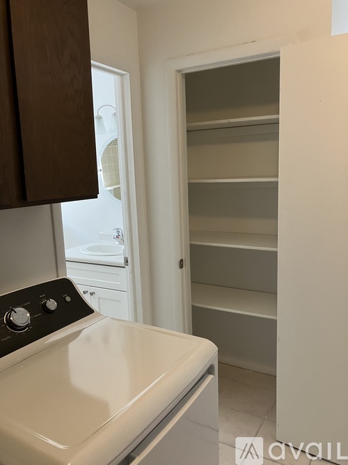 A white refrigerator with the door open and shelves visible.