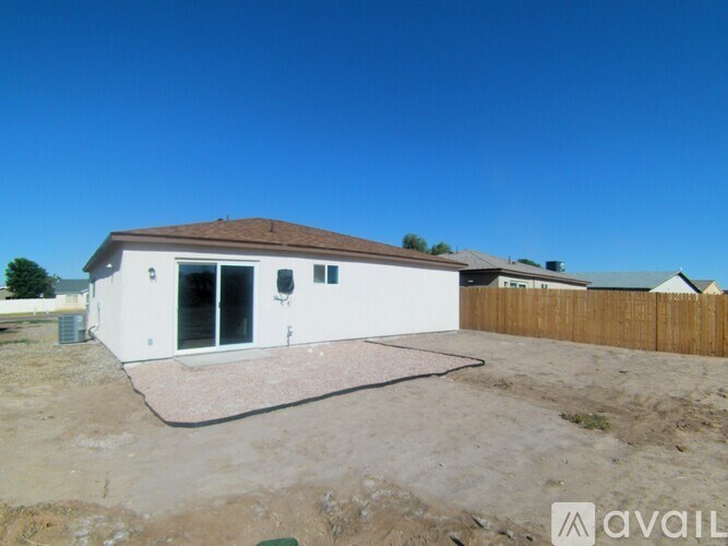 A house with a white exterior and a brown roof is available for purchase.