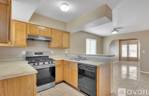 A kitchen with wooden cabinets and a stainless steel oven.
