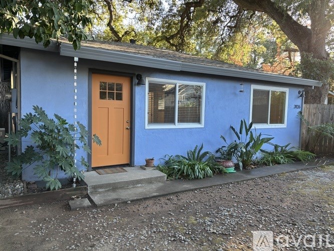 A blue house with a brown door and a brown step.