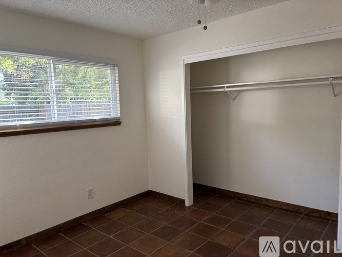 A room with a tiled floor and a closet with a sliding door.
