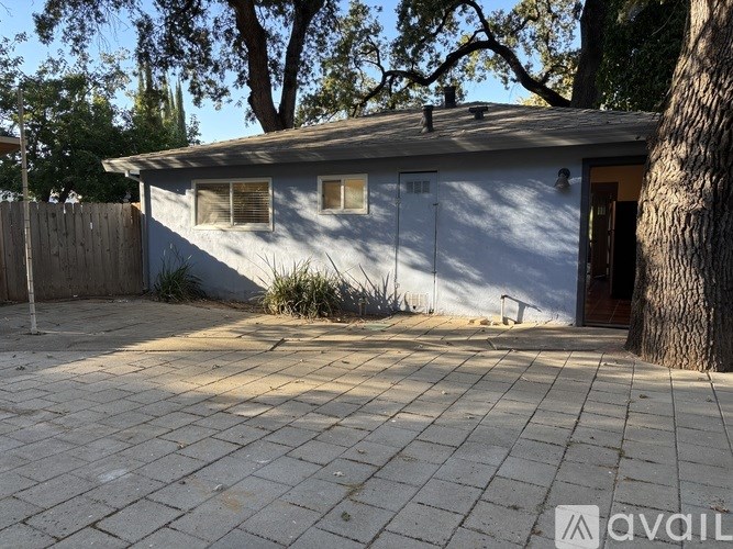 A small house with a brown door and a brown fence.