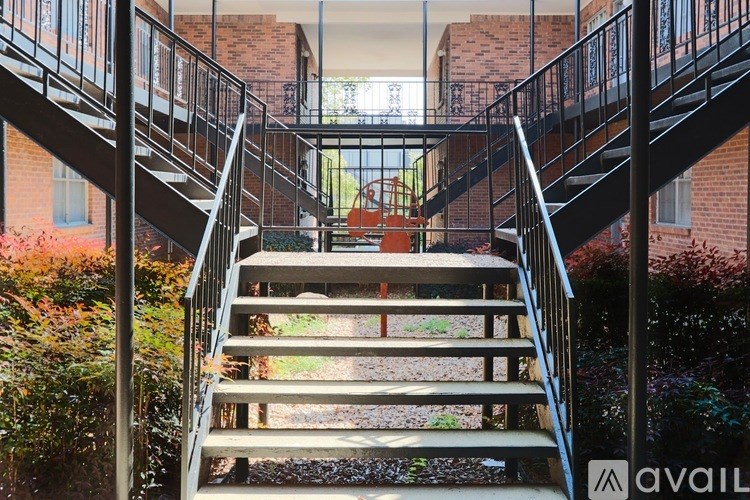 A staircase with a metal railing and wooden steps.