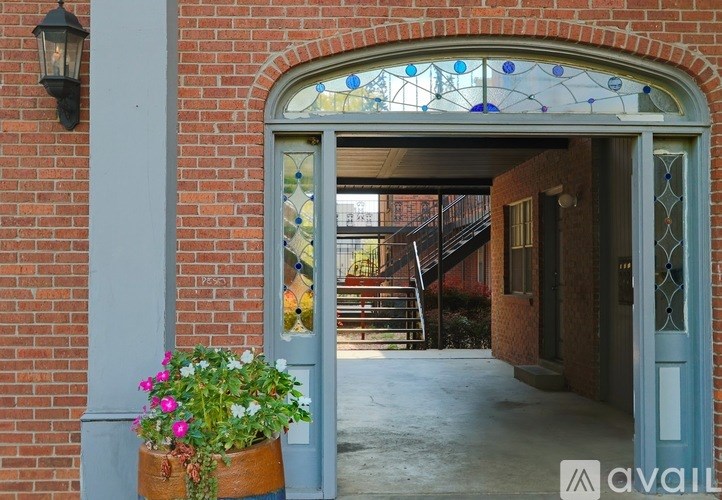 A house entrance with a glass window and a flower pot.