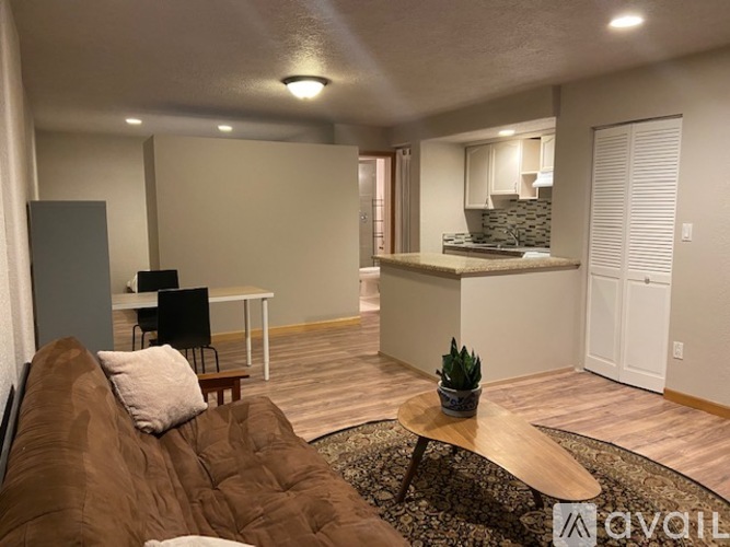 A living room with a brown couch and a wooden coffee table.