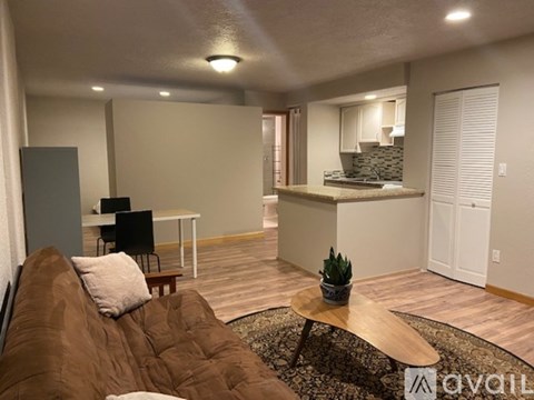 A living room with a brown couch and a wooden coffee table.