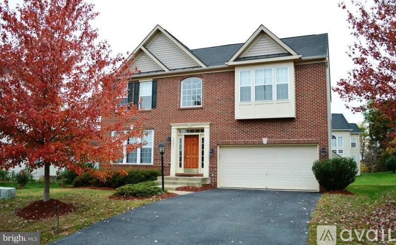 A house with a red door and a garage.
