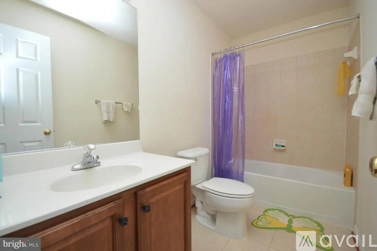 A bathroom with a toilet, sink, and shower.