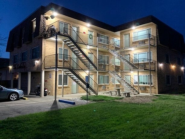 A building with a lit up staircase in front of it.