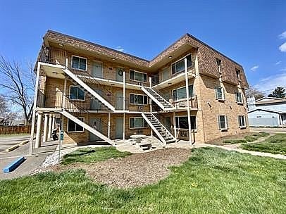 A large two-story house with a balcony on the second floor.