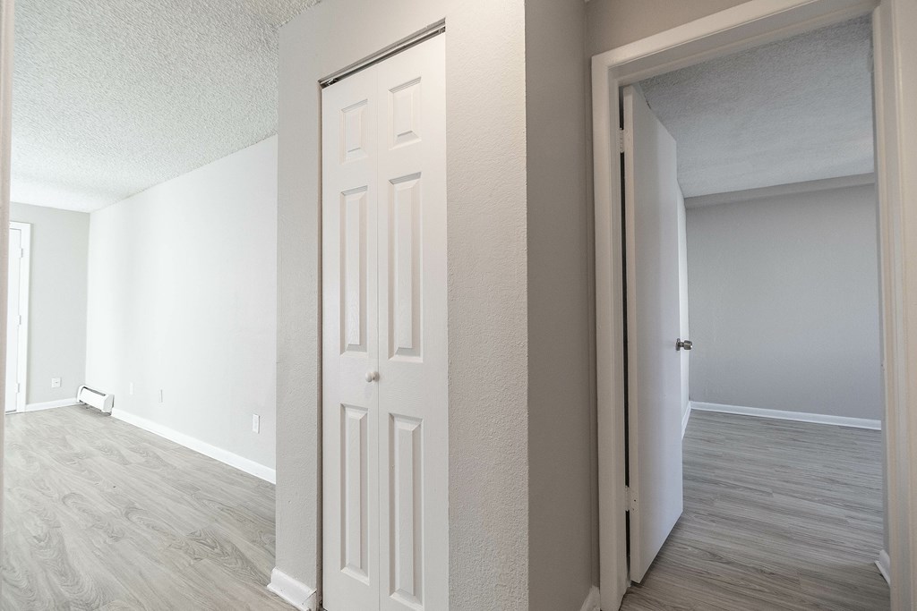 A white door is in a room with a grey floor.
