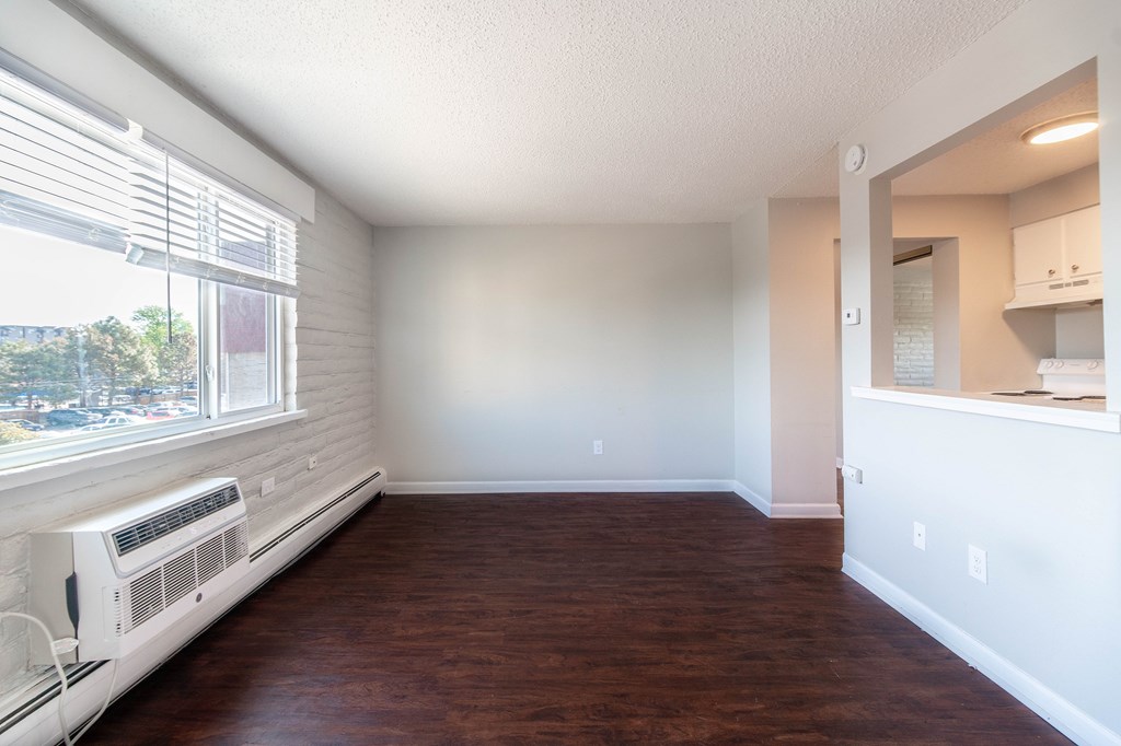 A room with a window and a fan.