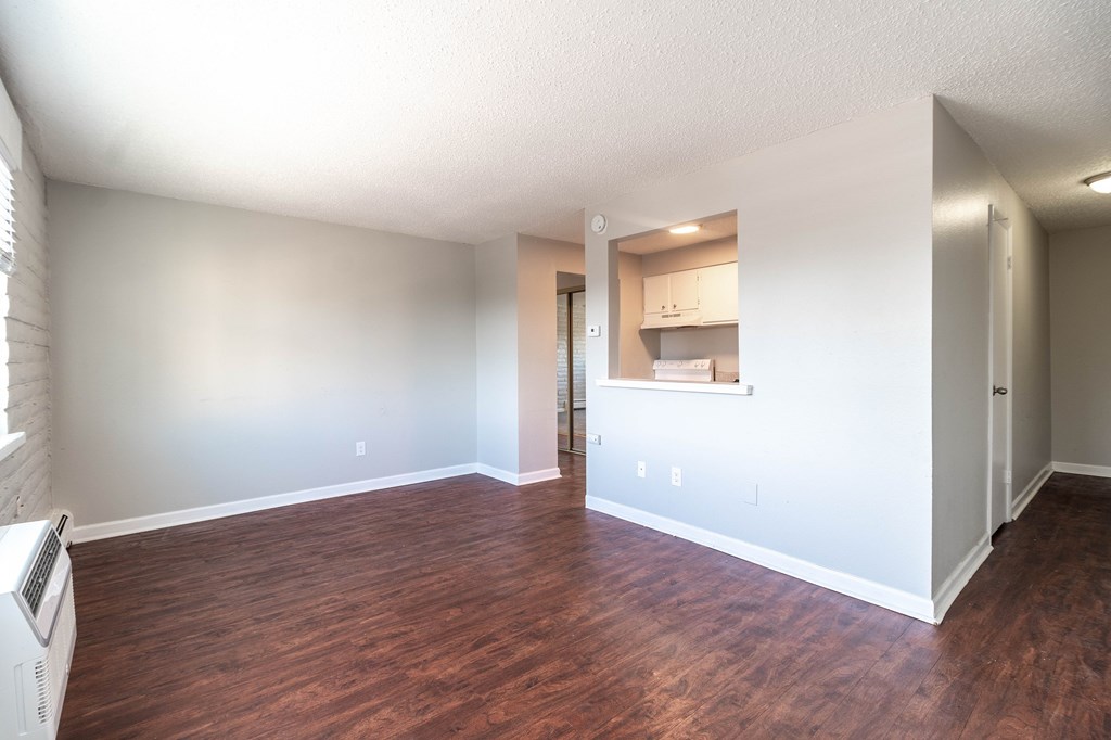 A room with wooden floors and white walls.