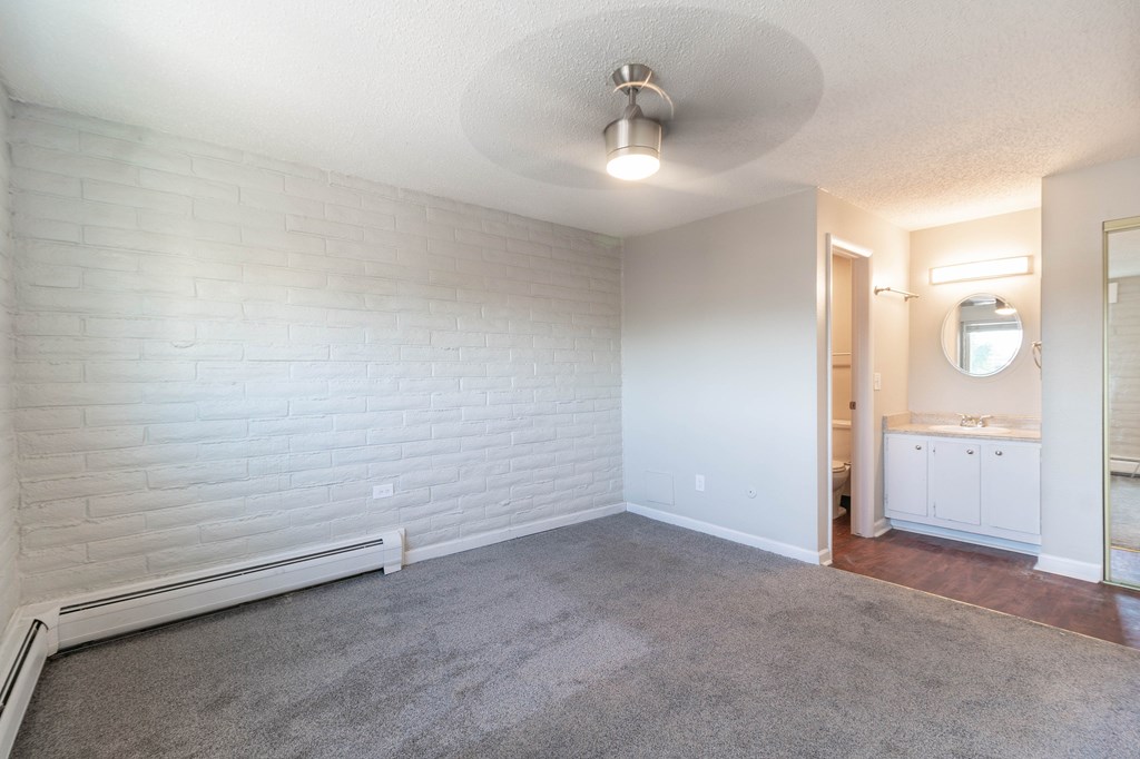 A white room with a grey carpet and a white ceiling.