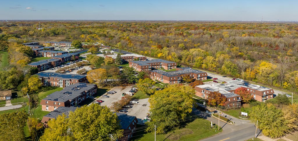 A brick building with a balcony and a door in the center.