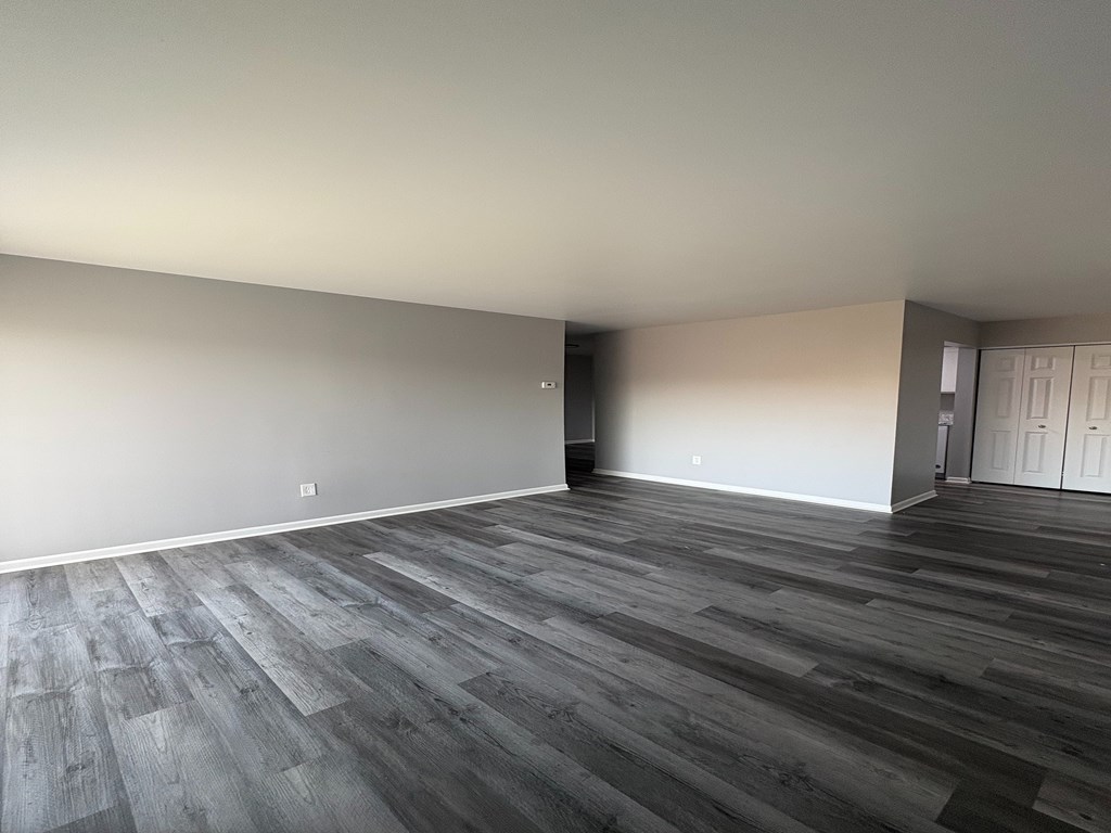 A room with a wooden floor and white walls.