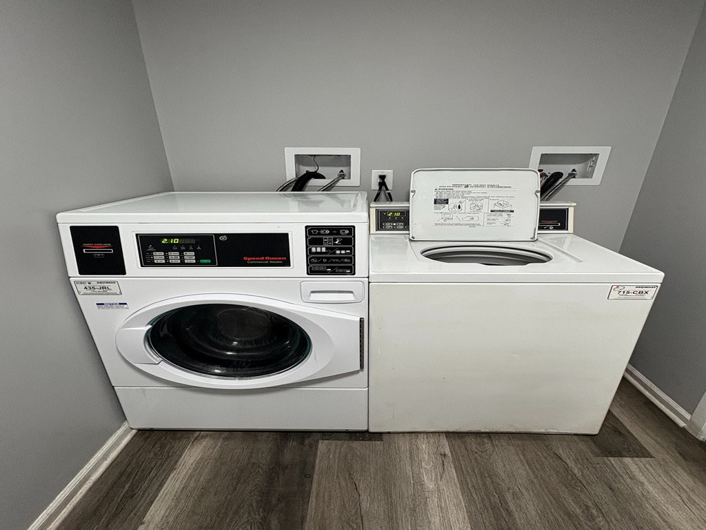 A white front loading washing machine with a digital display and control panel.