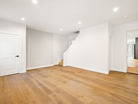 A room with wooden floors and white walls.