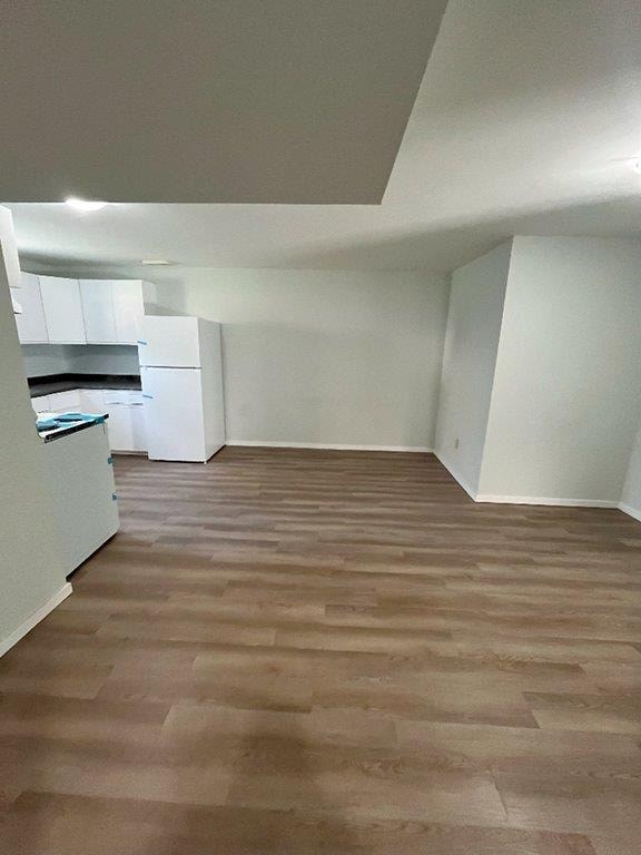 A room with a wooden floor and white walls.