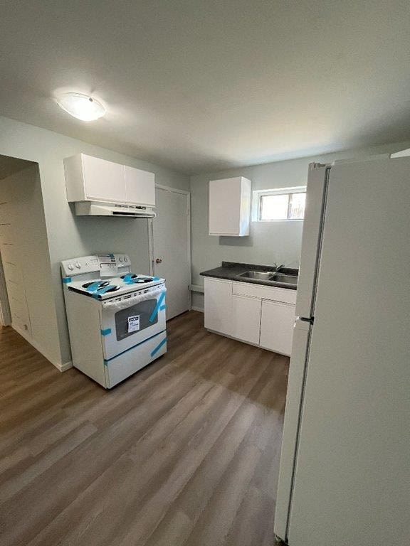 A kitchen with a refrigerator, a microwave, and a dishwasher.