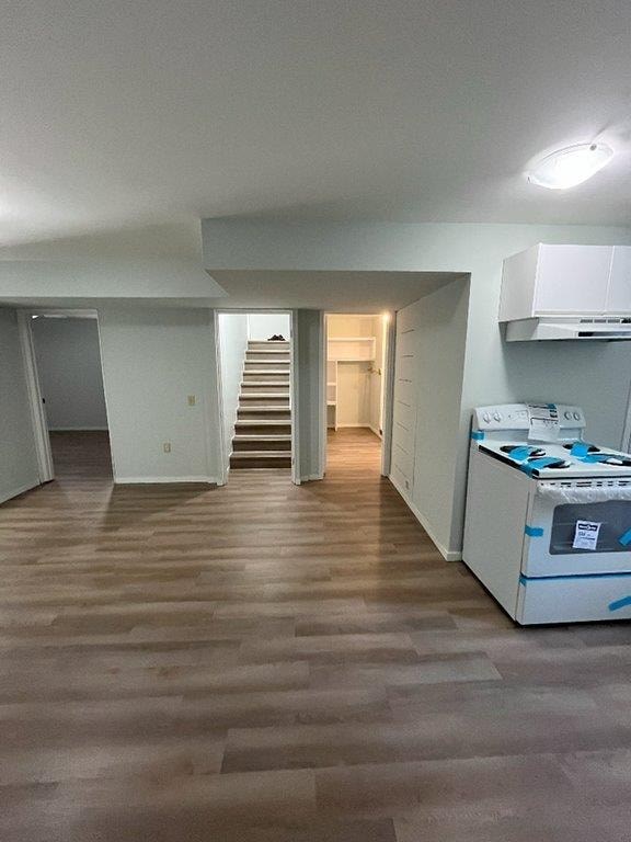 A room with a staircase and a white cabinet.