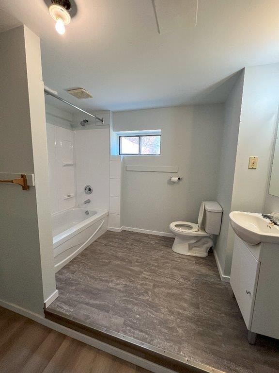 A bathroom with a toilet, sink, and bathtub.