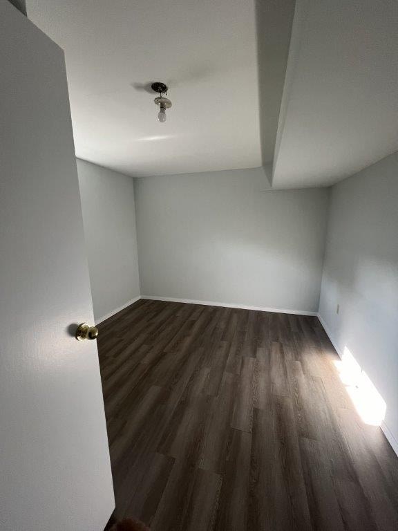 A room with a wooden floor and a white ceiling.