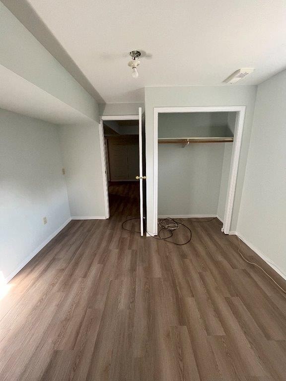 A room with a wooden floor and a white door.