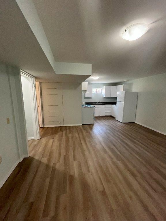 A room with wooden flooring and white walls.