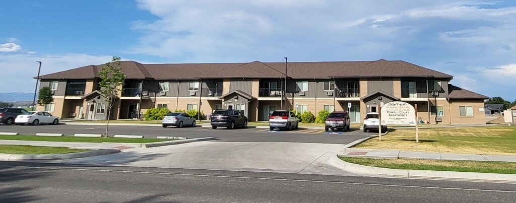 A large building with a parking lot in front of it.