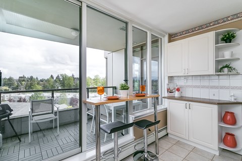 A kitchen with a table and chairs is shown.