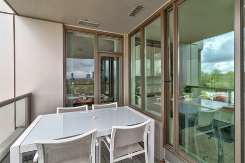 A table with chairs is set up outside a building.
