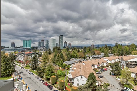 A cityscape with a cloudy sky and buildings in the background.