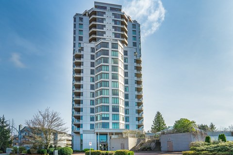 A tall residential building with balconies on each floor.
