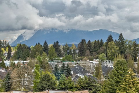 A mountain range is in the background of a cloudy day.