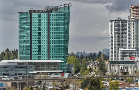 A large glass building with the words "Central City" on it.