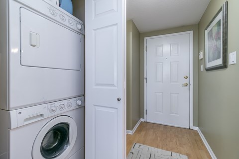 A white washing machine and dryer in a laundry room.