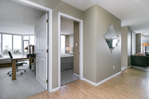 A bedroom with a bed, desk, and chair is shown.