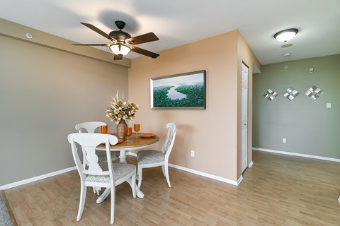 A dining room with a table set for two.