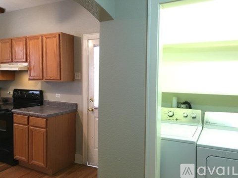 A kitchen with wooden cabinets and a washing machine.