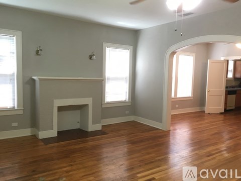 A living room with a fireplace and hardwood floors.
