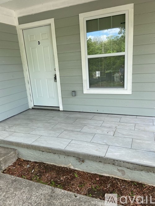 A white door is on the left and a window is on the right.