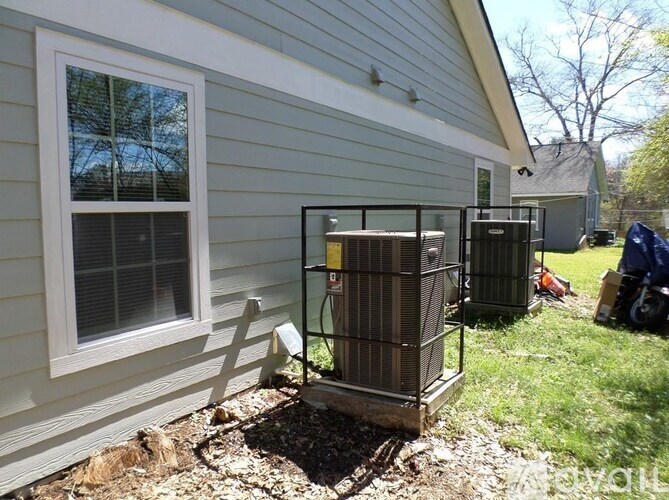 A house with a window and two air conditioning units outside.