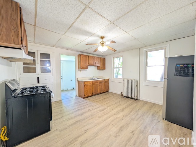 A room with wooden floors and a ceiling fan.